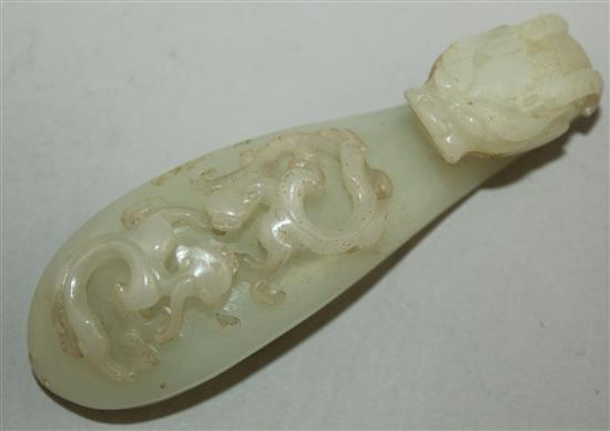 A Chinese white jade dragon belt hook, 18th century, 10cm, slight losses to chi-dragons, later piercings